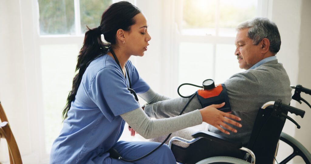 A nurse measures a patient's blood pressure using a sphygmomanometer.