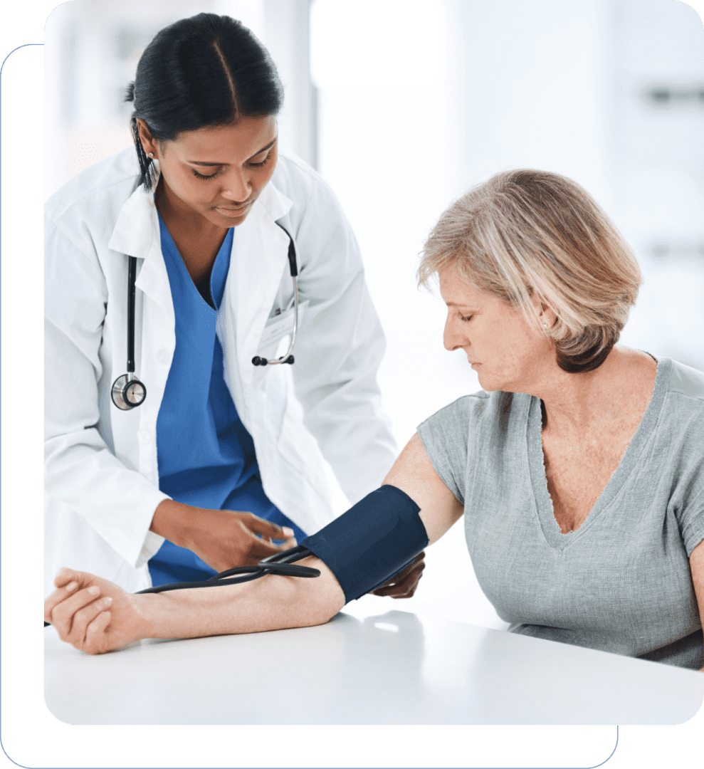 A female doctor checking blood pressure of a middle-aged woman.